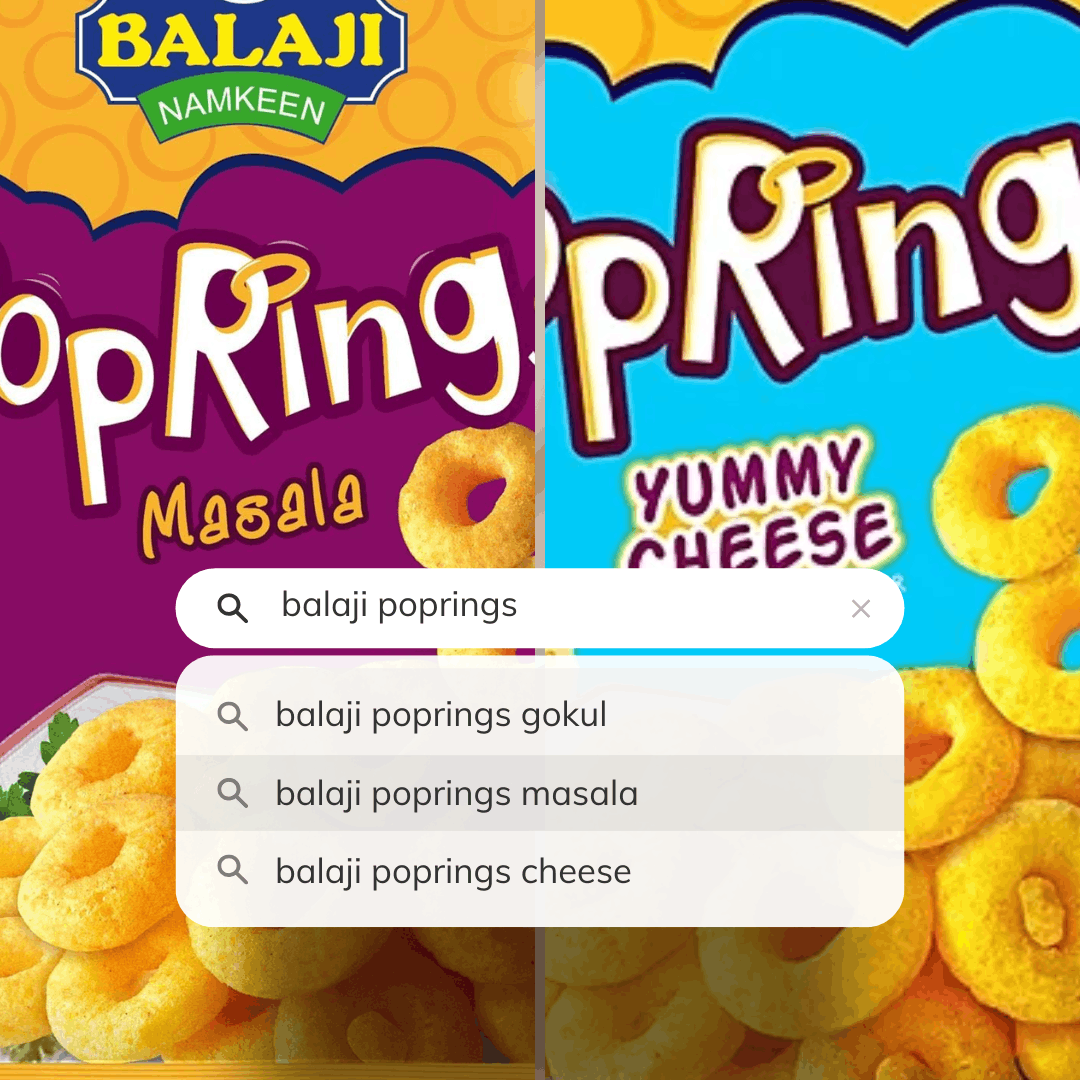 Two bowls of ring-shaped snacks on a slate board, one pale cheese-coloured and one orange masala-coloured.
